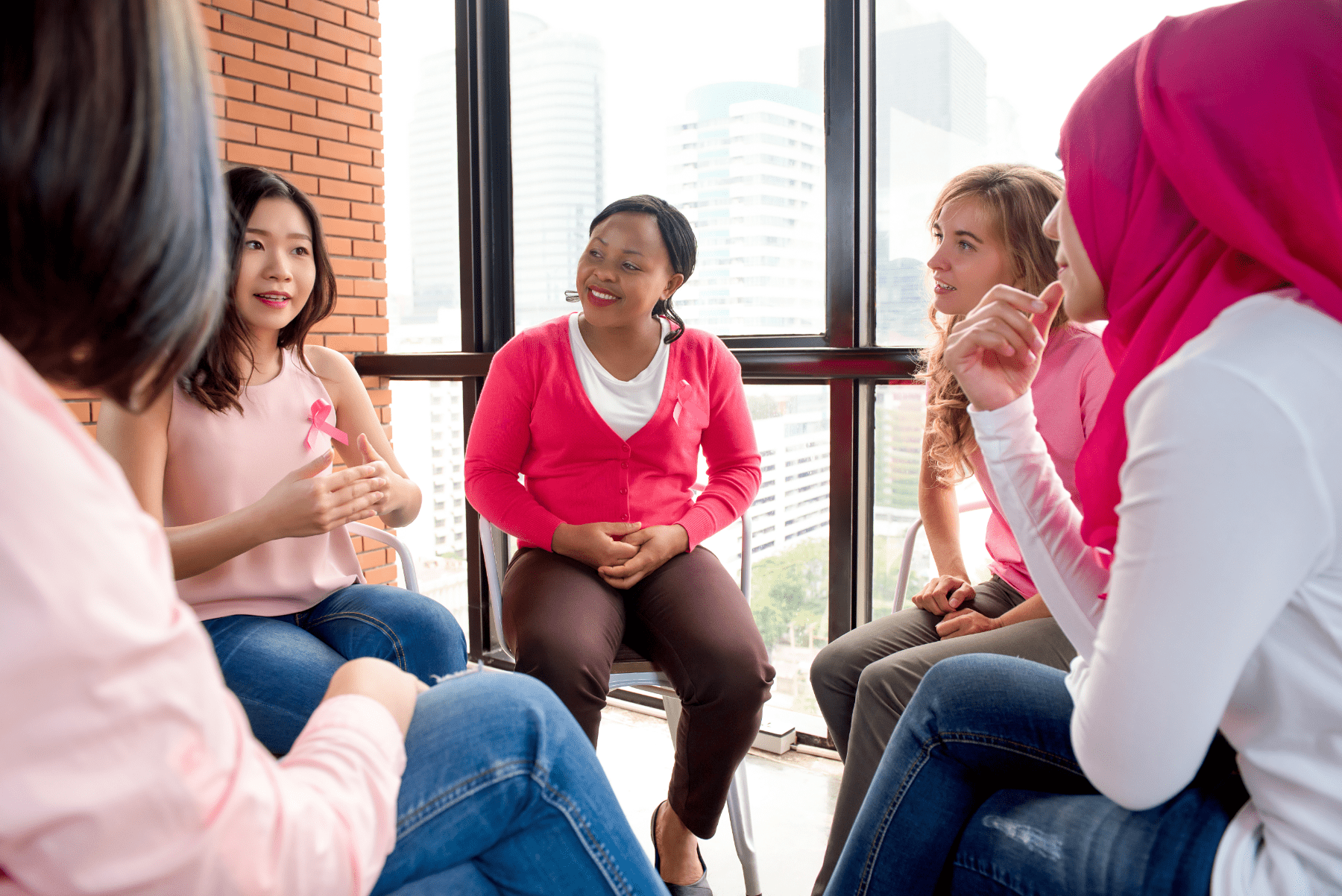 smiling-group-sitting-near-window_204181594-min