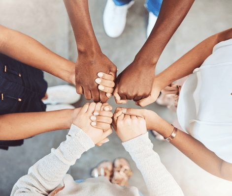 standing-group-holding-hands_530782571-min